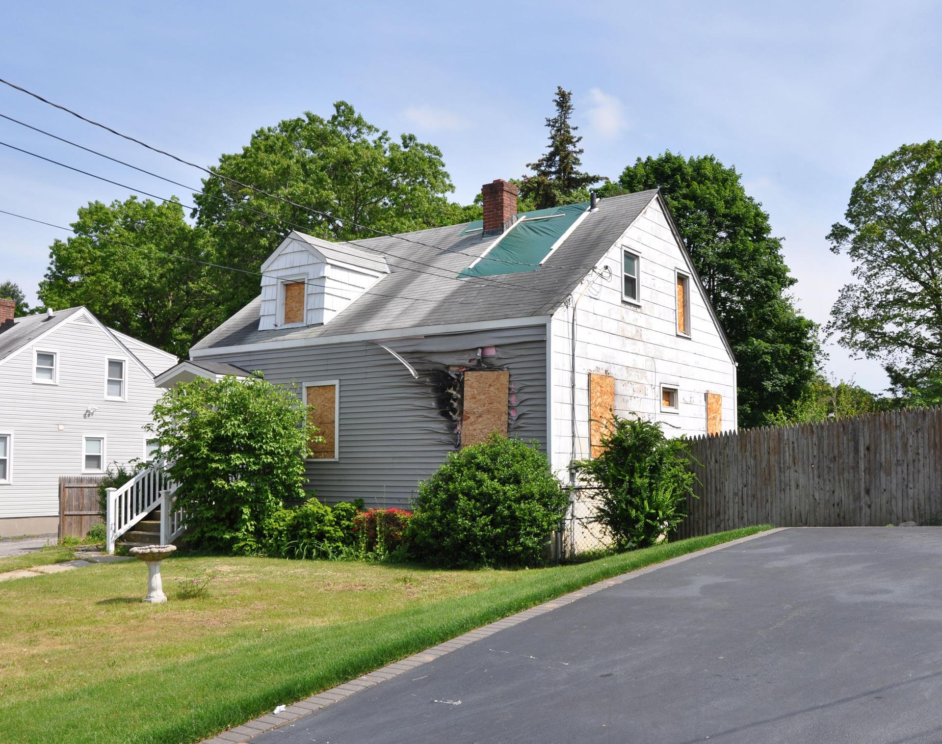 Suburban Home Fire Damage Boarded Windows
